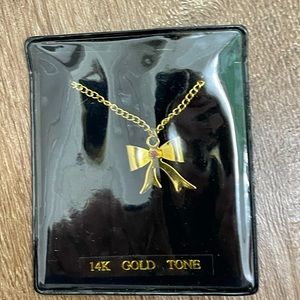 NWOT Gold Tone Bow Necklace - in original packaging.